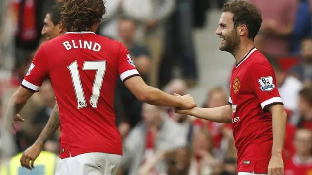 Daley Blind congratulates Manchester United team-mate Juan Mata