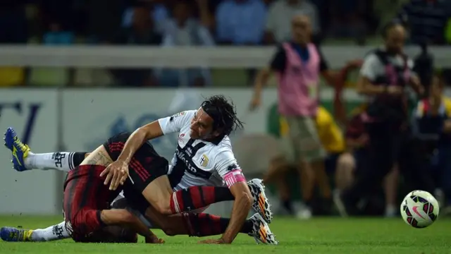 AC Milan's Jeremy Menez is brought down for a penalty