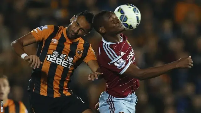 Hull City's Ahmed Elmohamady (left) challenges West Ham United's Diafra Sakho