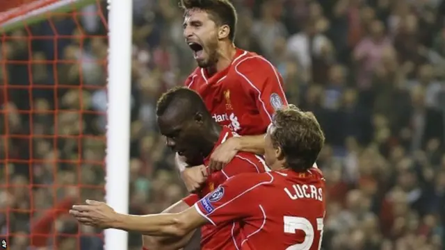 Liverpool's Mario Balotelli, center, celebrates with teammates