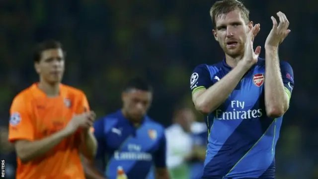 Arsenal's Per Mertesacker applauds the fans