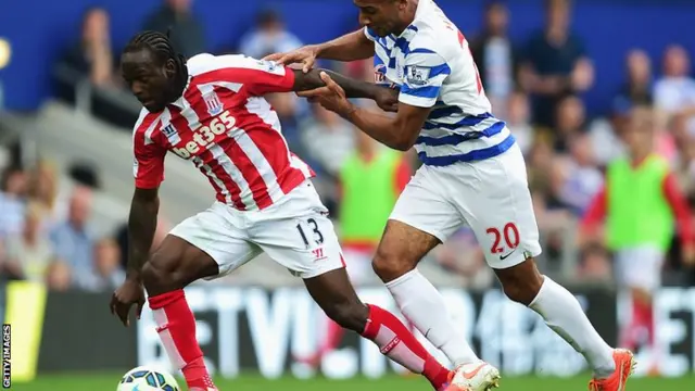 Victor Moses of Stoke shrugs off Karl Henry