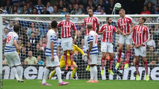 Nico Kranjcar curls a free-kick over Stoke's wall