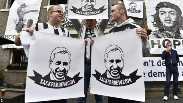 Fans with anti-Pardew posters outside St James' Park