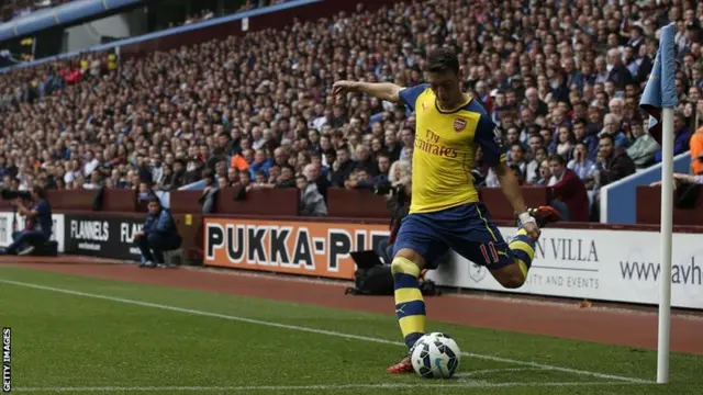 Arsenal's Mesut Ozil takes a corner