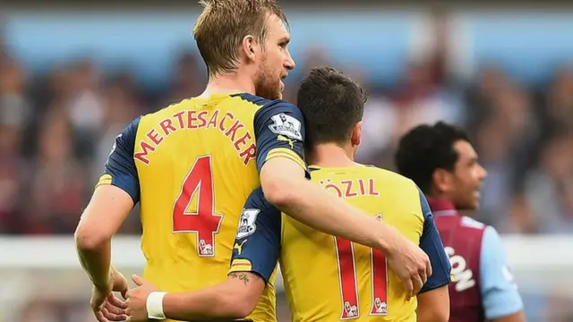 Arsenal stars Per Mertesacker and Mesut Ozil embrace at full-time