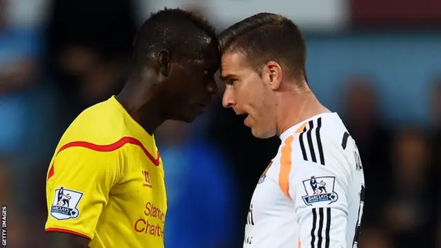 Liverpool striker Mario Balotelli clashes with West Ham keeper Adrian