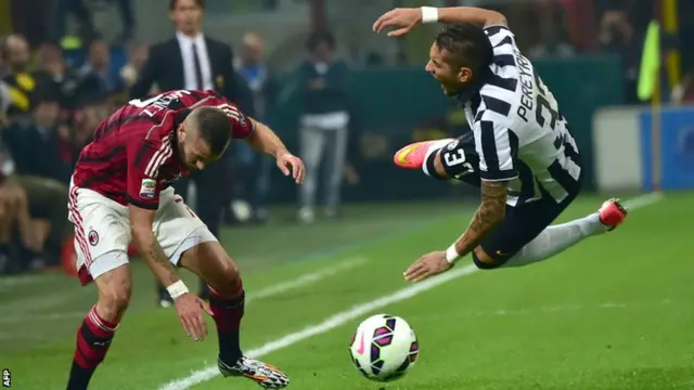 Jeremy Menez of AC Milan and Roberto Pereyra of Juventus clash