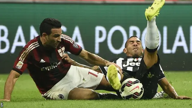 AC Milan's Adil Rami upends Juventus striker Carlos Tevez