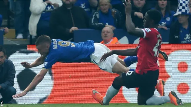 Manchester United defender Tyler Blackett brings down Leicester's Jamie Vardy