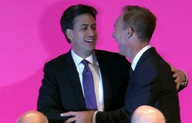 Jim Murphy receives a pat on the back from Ed Miliband as he concludes his speech