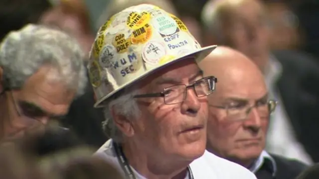 A delegate displays an unusual piece of headgear