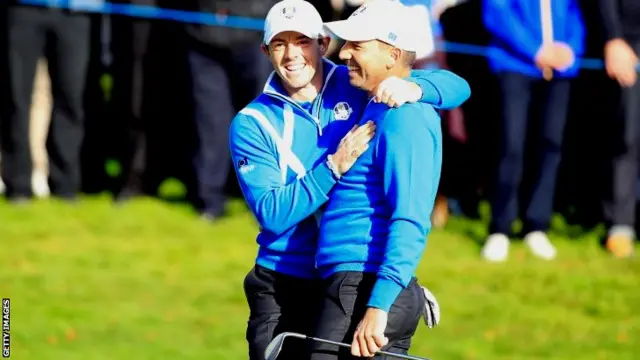 Sergio Garcia (R) of Europe is congratulated by Rory McIlroy