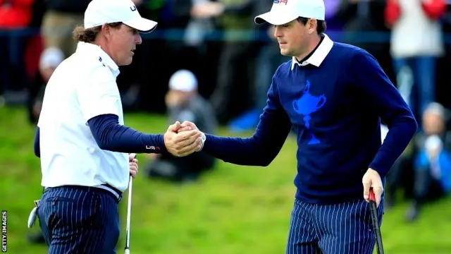 Phil Mickelson (L) of the United States shakes hands with Keegan Bradley