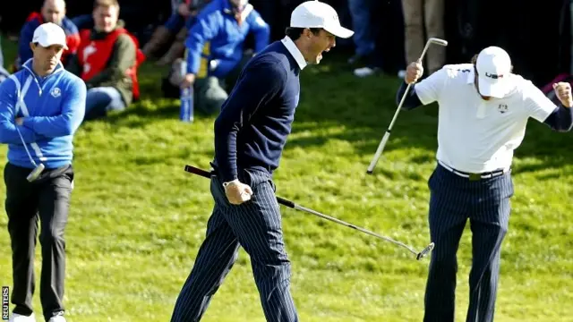 U.S. Ryder Cup player Keegan Bradley (C) celebrates winning the 16th hole with teammate Phil Mickelson