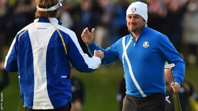 Graeme McDowell of Northern Ireland (R) and Victor Dubuisson of Franc