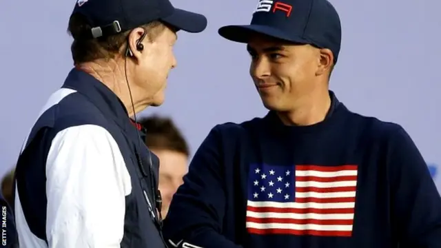 US team captain Tom Watson, left, talks with Rickie Fowler