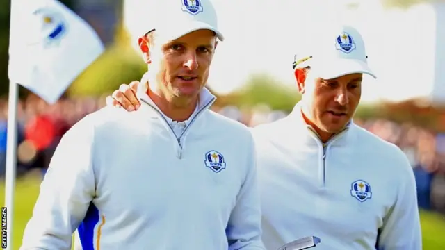 Henrik Stenson (R) of Europe congratulates Justin Rose