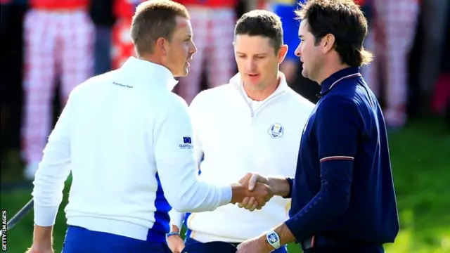 Henrik Stenson (L) and Justin Rose of Europe shake hands with Bubba Watson of the United States