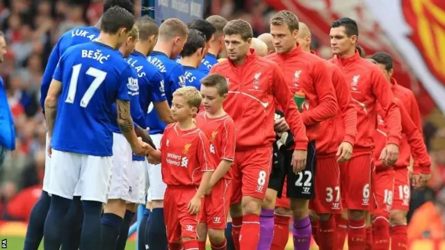 Liverpool and Everton players - and mascots - shake hands