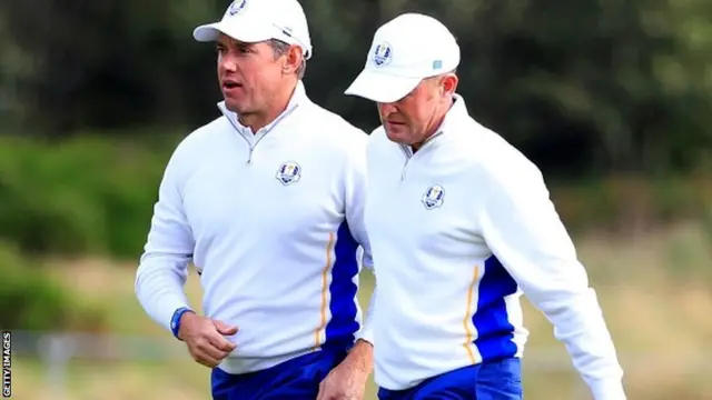 Jamie Donaldson (R) of Europe celebrates his birdie putt with Lee Westwood