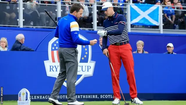 Graeme McDowell of Europe talks to Jordan Spieth of the United States