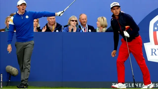 Rory McIlroy of Europe points in the direction of his tee shot with Rickie Fowler of the United States