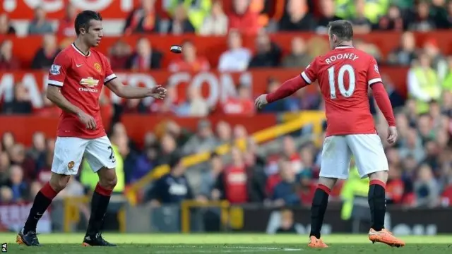 Wayne Rooney throws armband to Robin van Persie