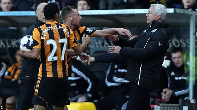 Hull City's David Meyler (left) confronts Newcastle United's manager Alan Pardew