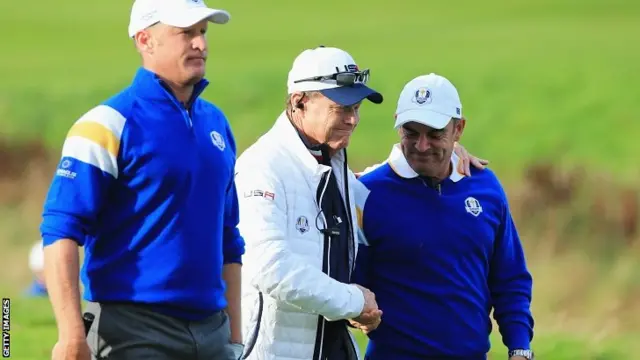 Europe team captain Paul McGinley shakes hands with United States team captain Tom Watson with Jamie Donaldson