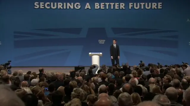 George Osborne on stage while delegates applaud