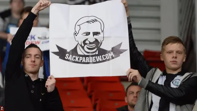 Newcastle fans hold up a 'Sack Pardew' poster at the Stoke game