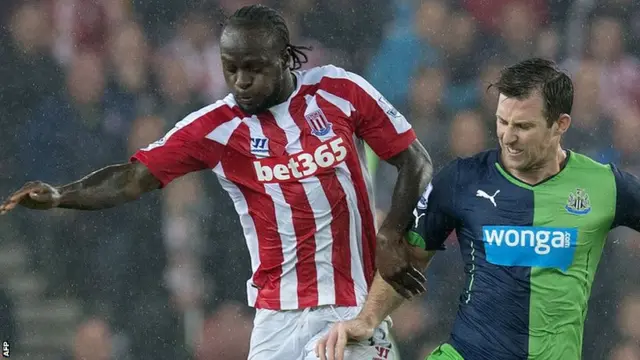 Stoke City striker Victor Moses holds off Newcastle defender Mike Williamson