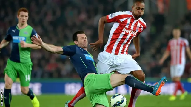 Stoke's Steven N'Zonzi is tackled by Newcastle defender Mike Williamson