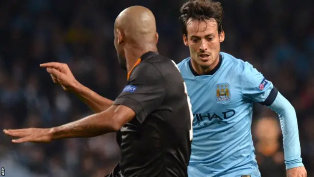 Manchester City's David Silva takes on Maicon