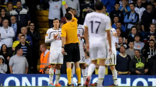 Tottenham Hotspur's Vlad Chiriches receives a yellow card