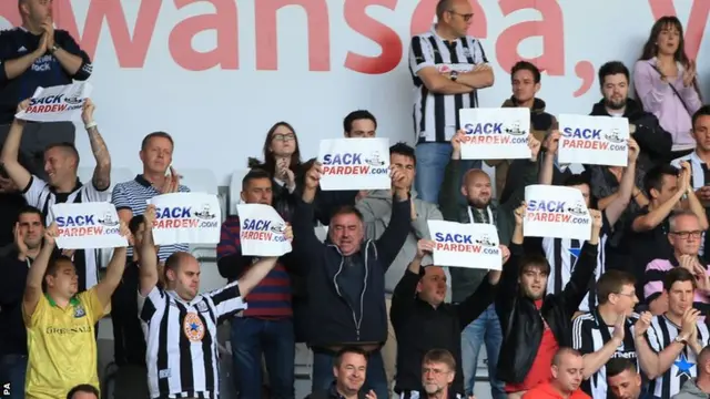 Newcastle fans hold Sack Pardew posters