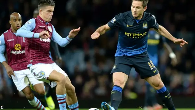 Jack Grealish of Aston Villa tackles Manchester City's Frank Lampard