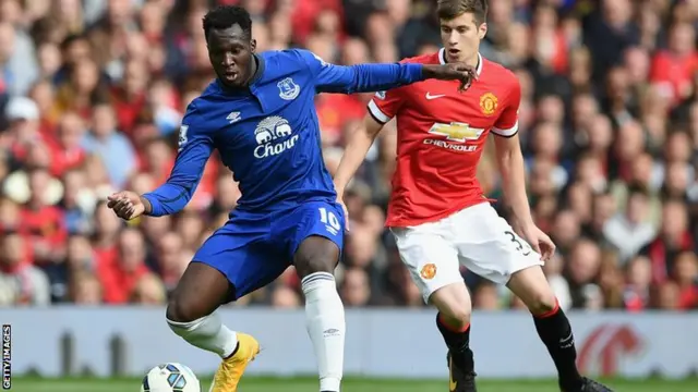 Everton striker Romalu Lukaku takes on Manchester United defender Paddy McNair