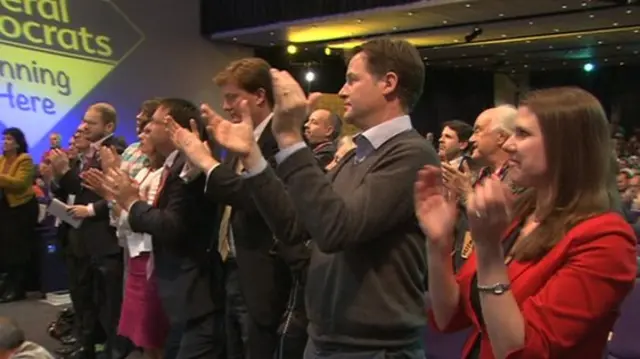 Lib Dem leader Nick Clegg leads the standing ovation for his business secretary, Vince Cable