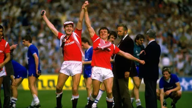 Norman Whiteside celebrates