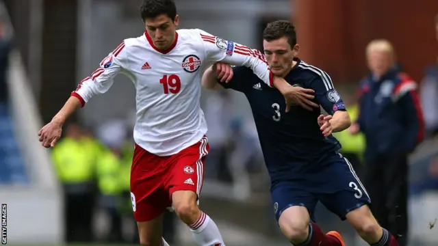 Andrew Robertson of Scotland battles for the ball