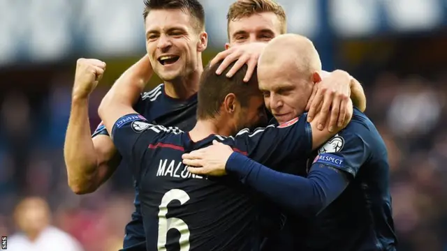 Shaun Maloney is congratulated by his Scotland team-mates after his deflected effort gave them the lead against Georgia