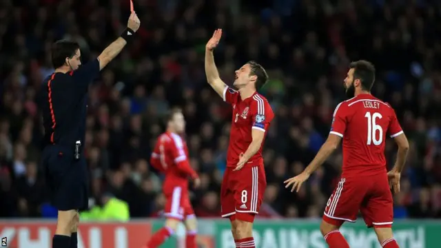 Andy King of Wales is handed a straight red card