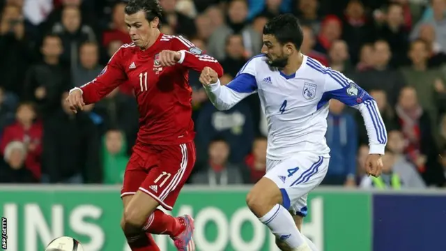 Gareth Bale is challenged by Girgos Merkis