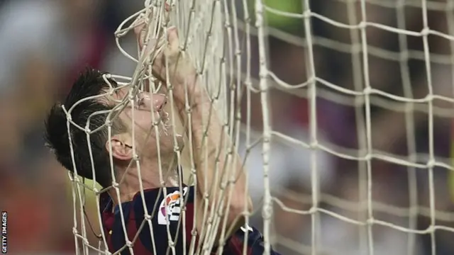 Lionel Messi falls in to the net