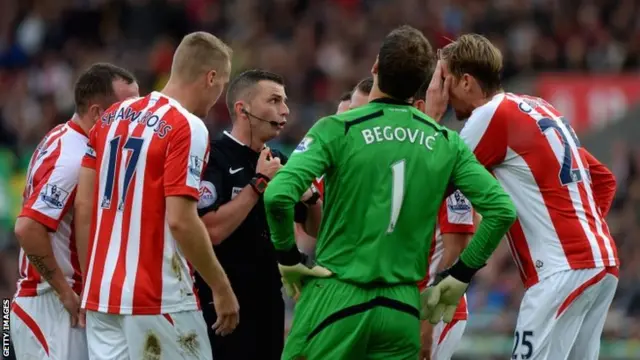 Stoke City players surround the referee