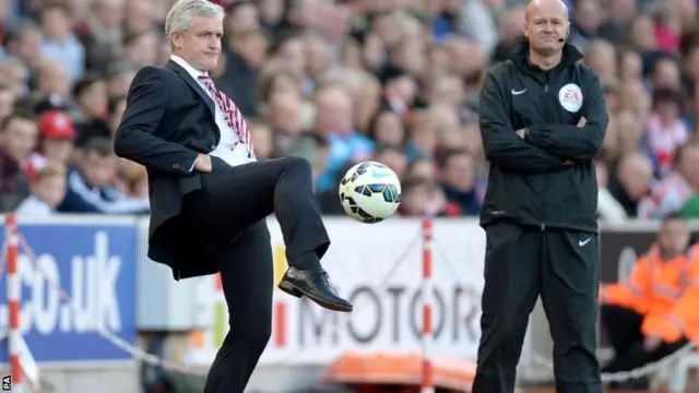 Mark Hughes kicks the ball