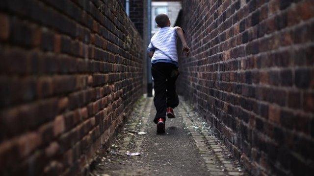 Boy running through narrow streets