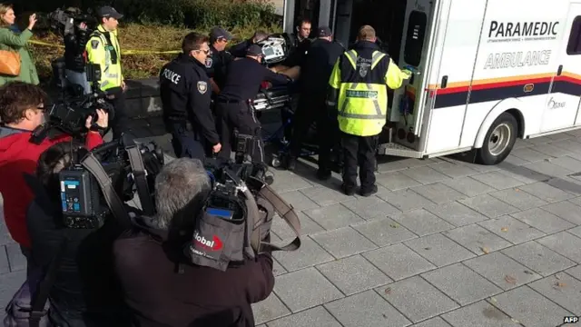 Wounded soldier taken away. 22 Oct 2014